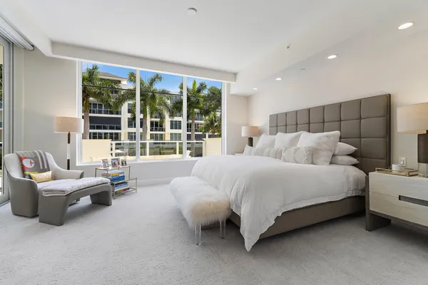 a bedroom with bed and glass window