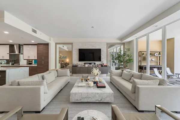a living room with fireplace furniture and a flat screen tv