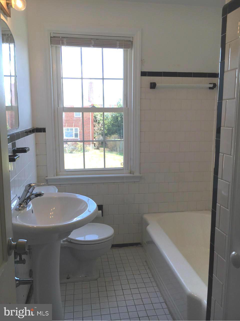 1723 Edgewood Road Baltimore, MD 21286 - Photo 15 of 24 a bathroom with a sink a toilet a tub and shower