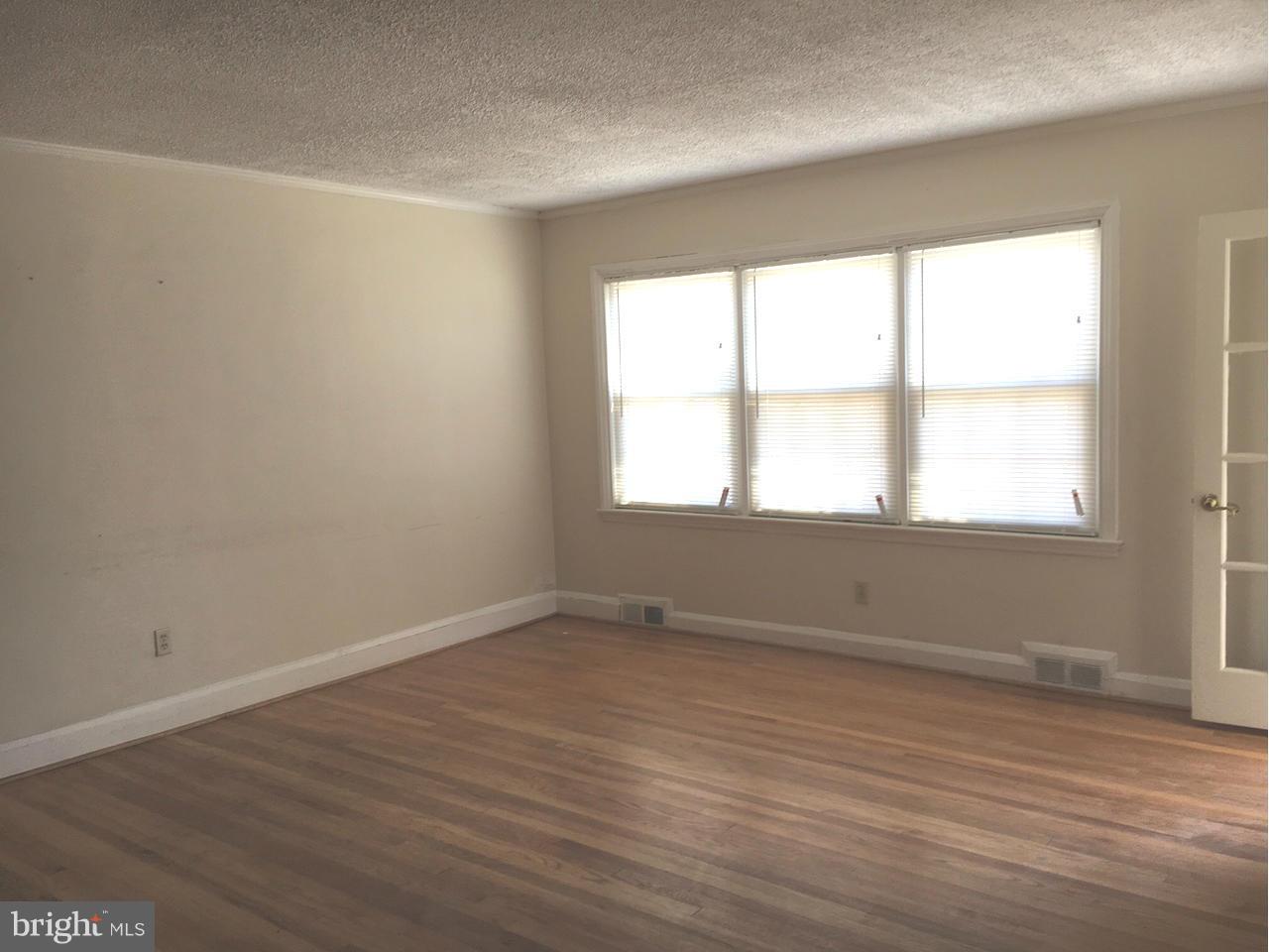 1723 Edgewood Road Baltimore, MD 21286 - Photo 4 of 24 wooden floor in an empty room with a window