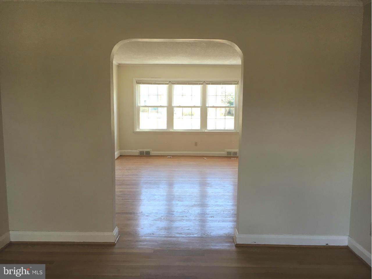 1723 Edgewood Road Baltimore, MD 21286 - Photo 5 of 24 an empty room with wooden floor and windows