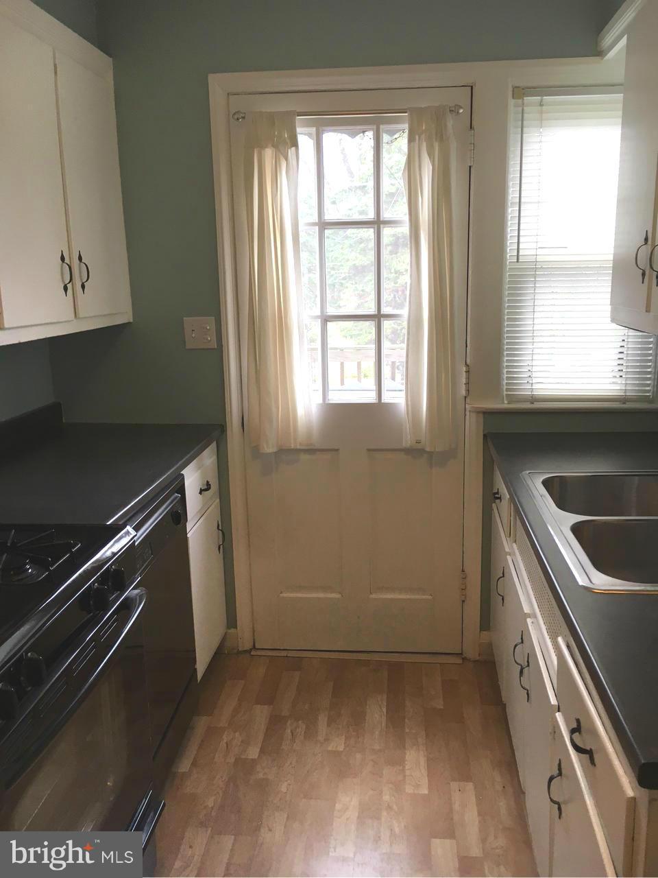 1723 Edgewood Road Baltimore, MD 21286 - Photo 8 of 24 a kitchen with a sink a stove and cabinets