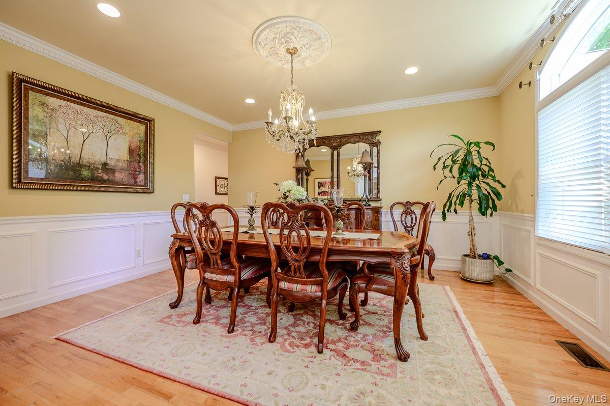 129 Round Swamp Road Huntington, NY 11743 - Photo 48 of 49 Dining room featuring wood-finish flooring, wainscoting, crown molding, and recessed lighting