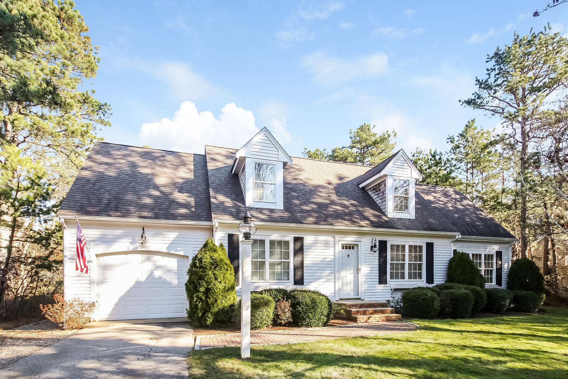 9 Wintergreen Road Mashpee, MA 02649 - Photo 1 of 24 a front view of a house with garden