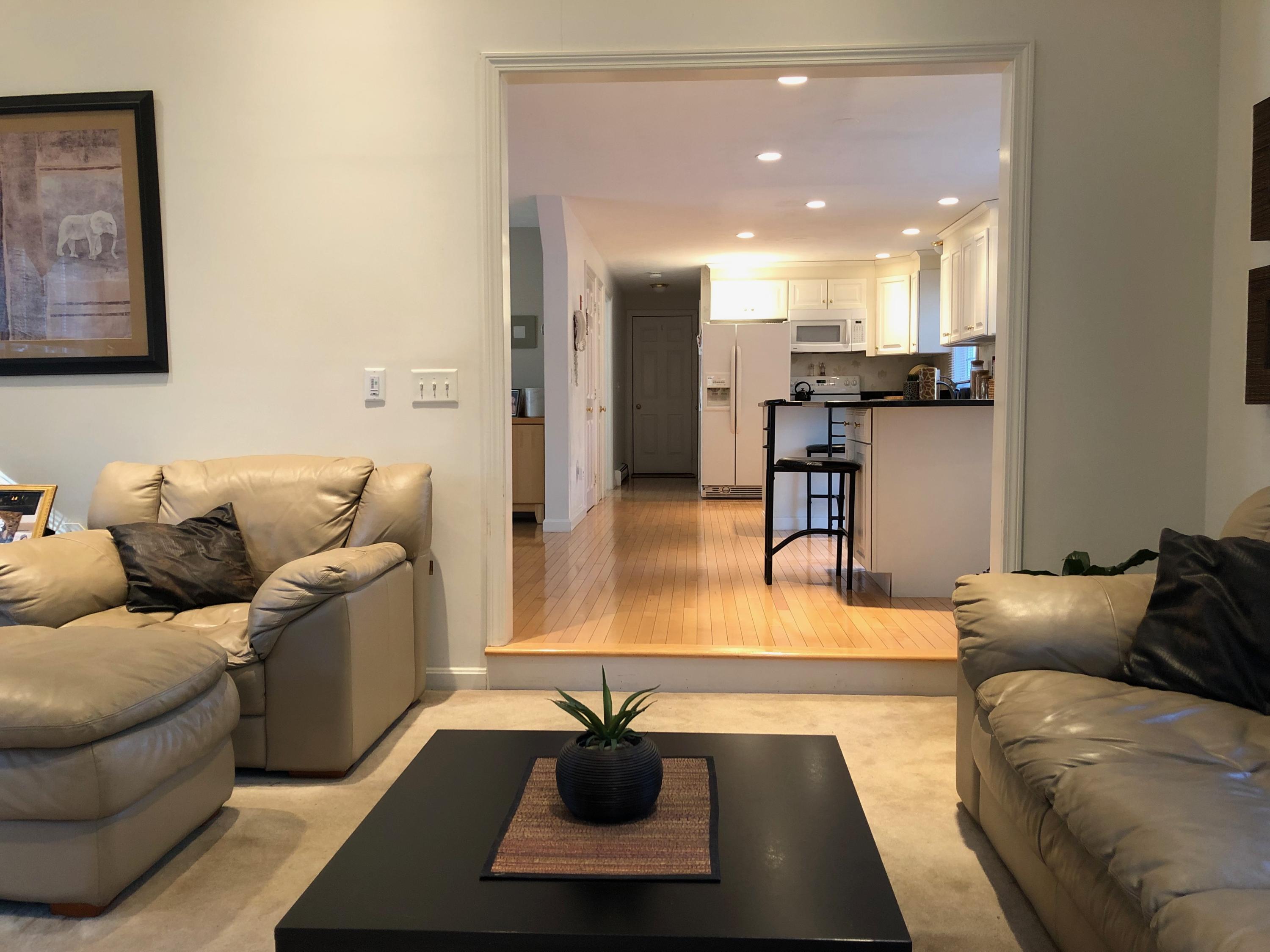 9 Wintergreen Road Mashpee, MA 02649 - Photo 11 of 24 a living room with furniture and a view of kitchen