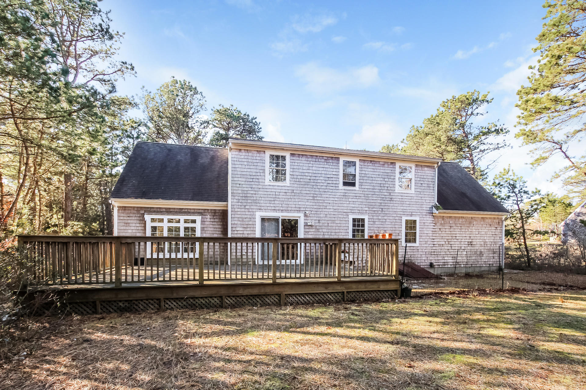 9 Wintergreen Road Mashpee, MA 02649 - Photo 21 of 24 a front view of a house with a yard