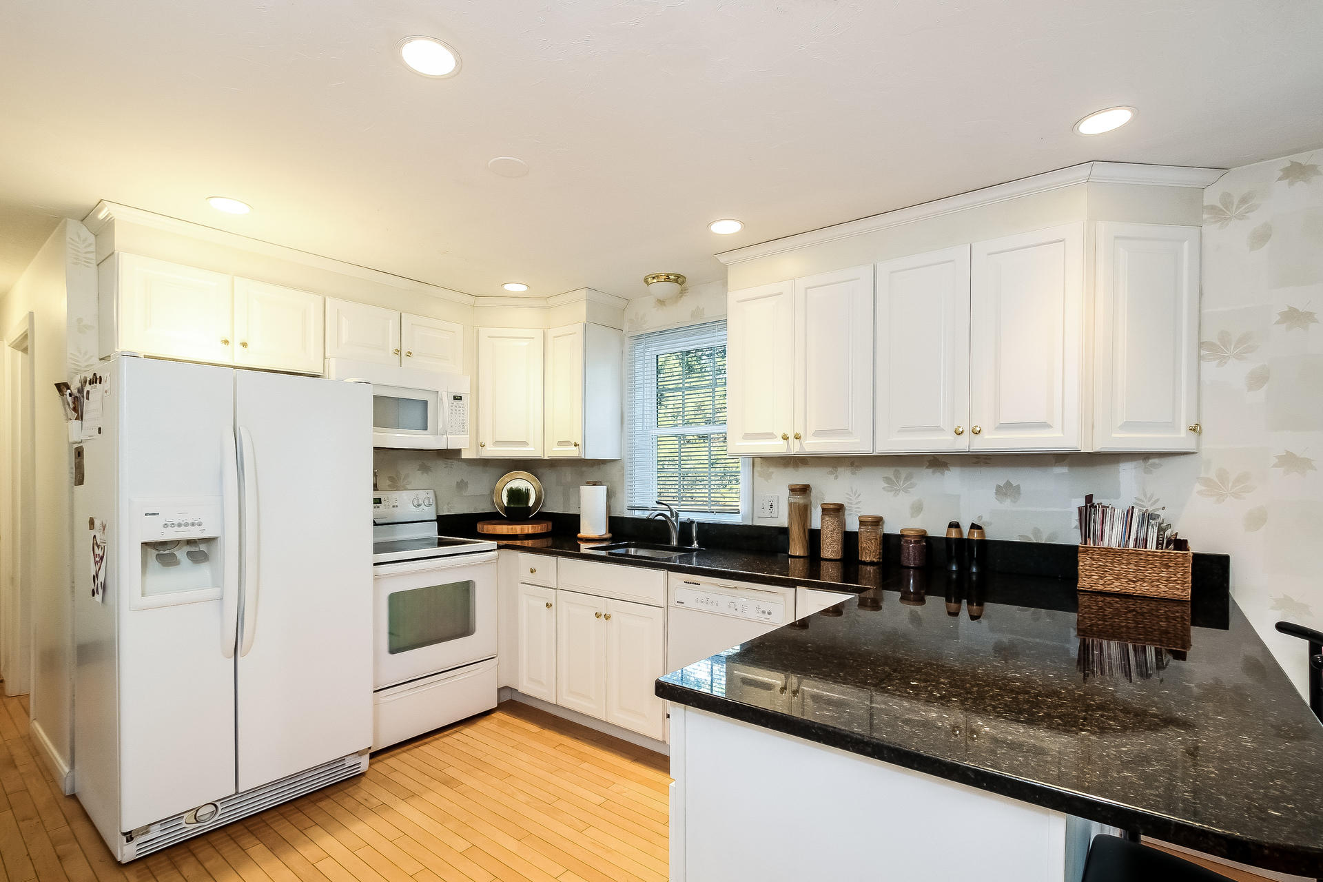 9 Wintergreen Road Mashpee, MA 02649 - Photo 4 of 24 a kitchen with granite countertop white cabinets and white appliances