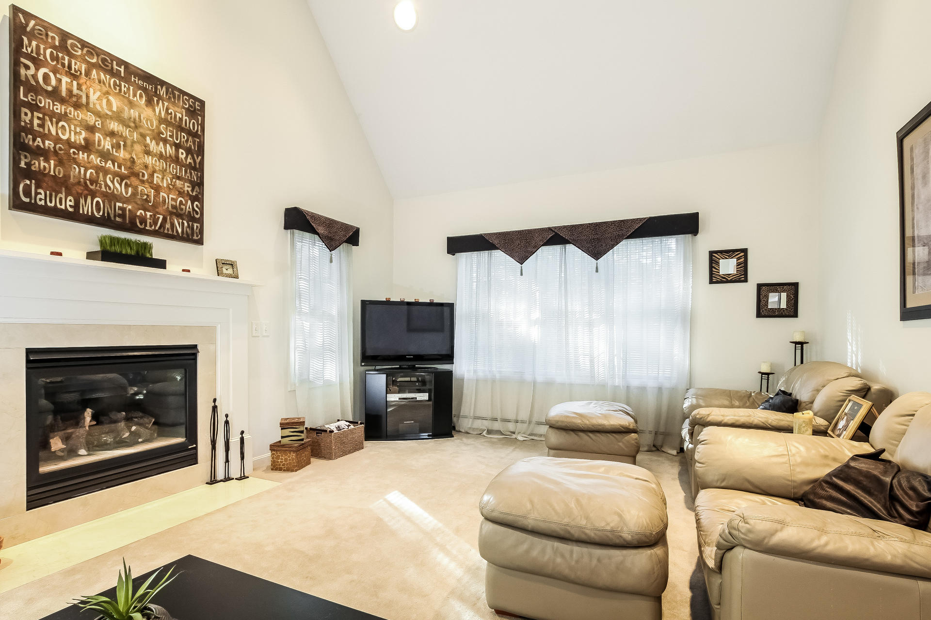 9 Wintergreen Road Mashpee, MA 02649 - Photo 9 of 24 a bedroom with furniture and a fireplace