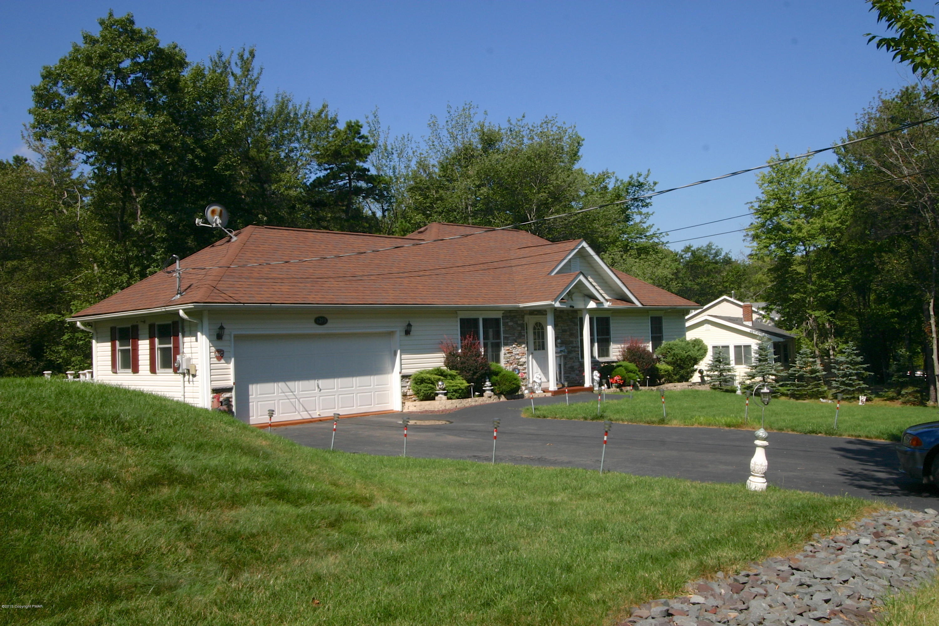6293 Laurel Road Pocono Summit, PA 18346 - Photo 3 of 32 a front view of a house with a yard