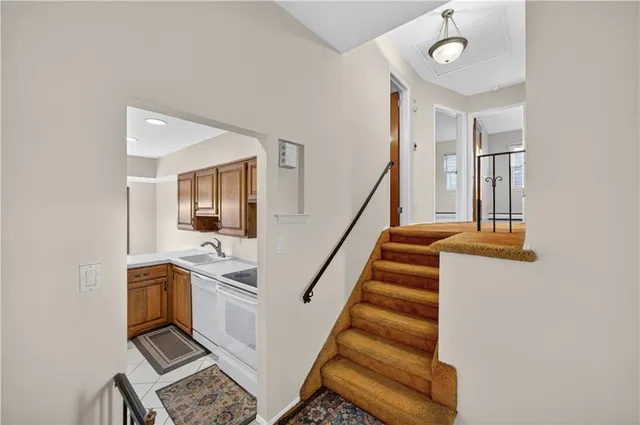 a bathroom with a granite countertop sink a toilet a mirror and shower