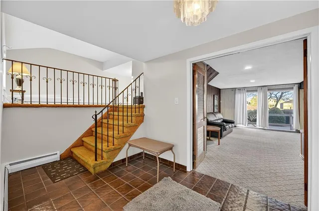 a view of an entryway with wooden floor and stairs