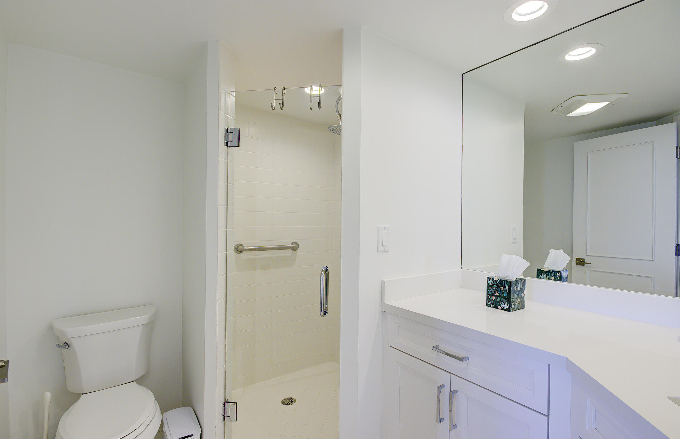 120 South Ocean Boulevard, Unit 4A Delray Beach, FL 33483 - Photo 12 of 36 a bathroom with a sink a toilet and shower