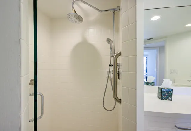 a large bedroom with bed and window