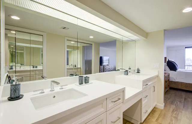 a bathroom with a shower a toilet and a glass door