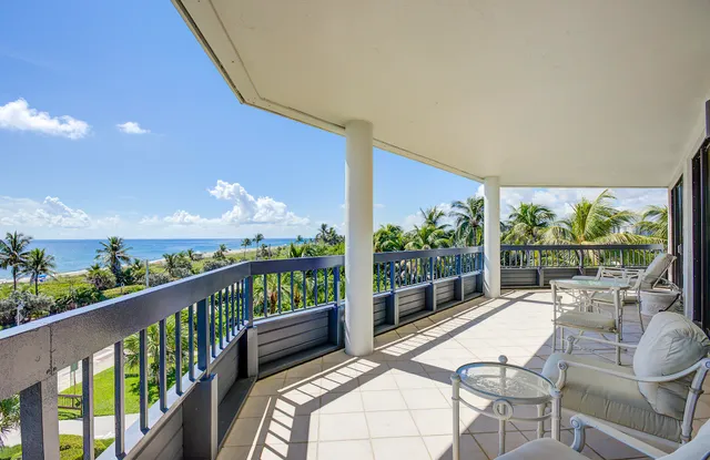a view of a dining room with furniture and a large window