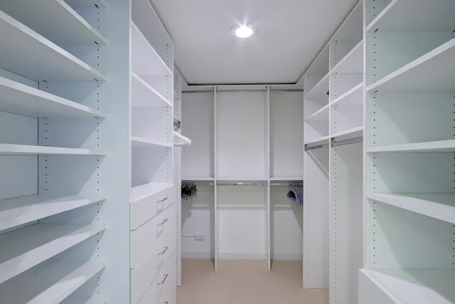 a view of walk in closet with empty racks