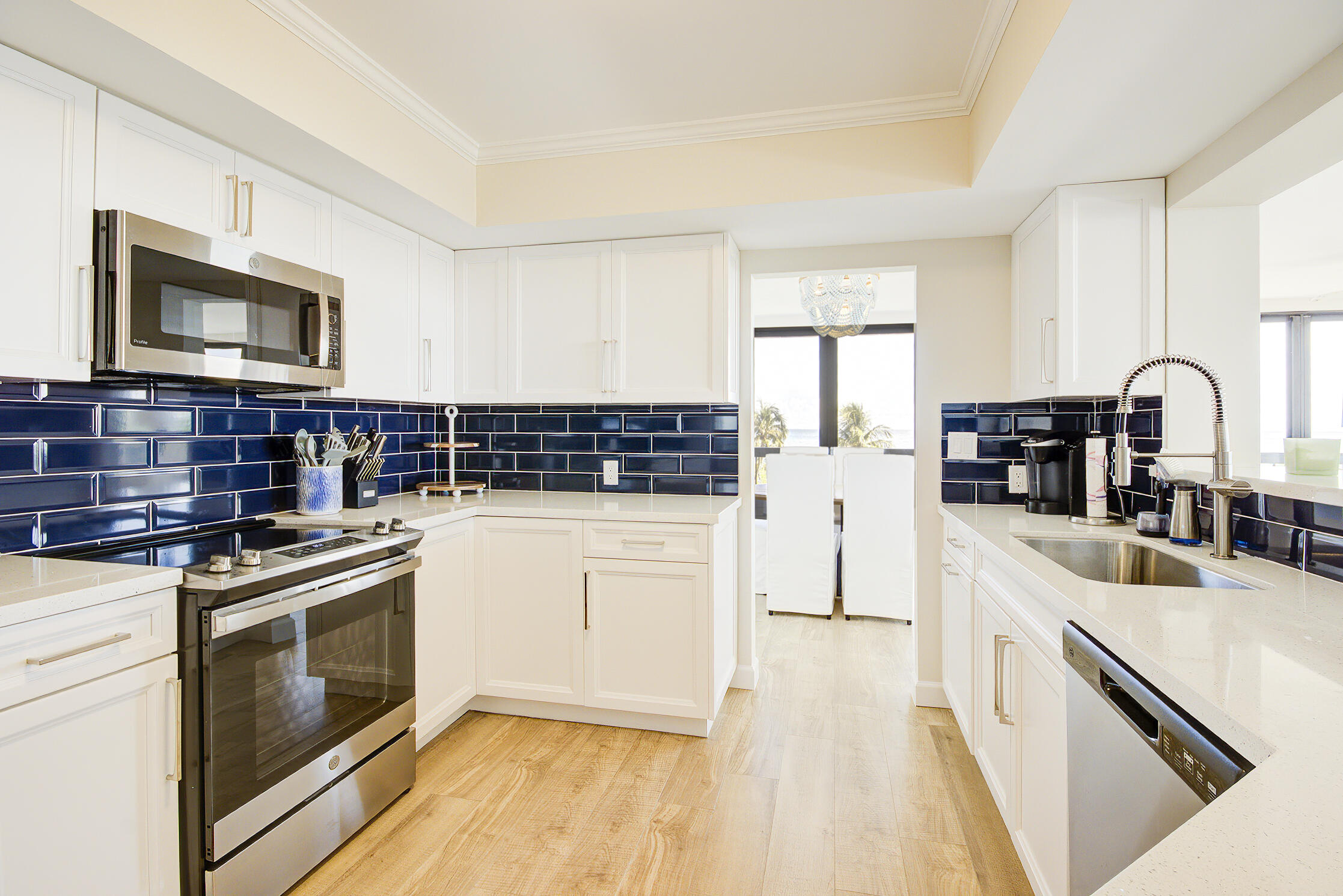 120 South Ocean Boulevard, Unit 4A Delray Beach, FL 33483 - Photo 9 of 36 a kitchen with stainless steel appliances a stove sink and microwave