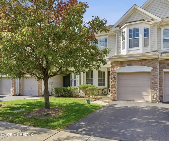 a front view of house with yard and green space