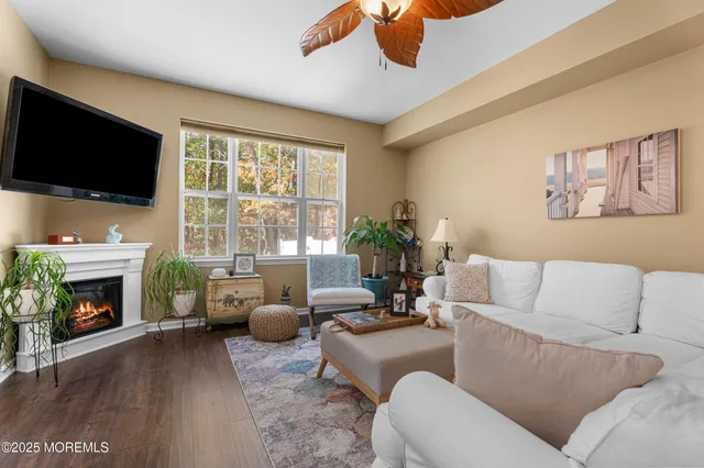 a living room with furniture a fireplace and a flat screen tv