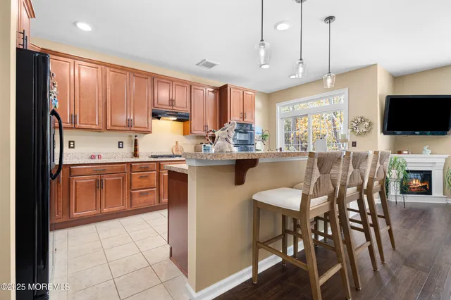 a kitchen with stainless steel appliances granite countertop a sink and cabinets