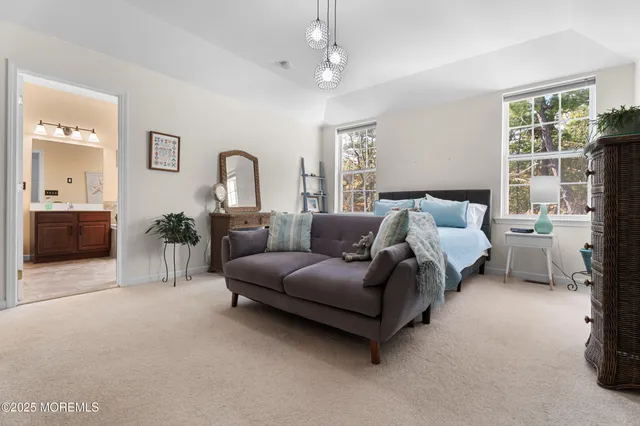 a spacious bathroom with a tub double sink window and mirror