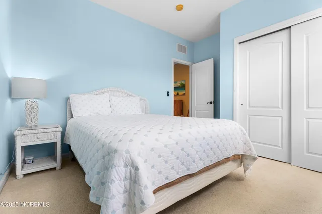 a bedroom with a bed tv and a window