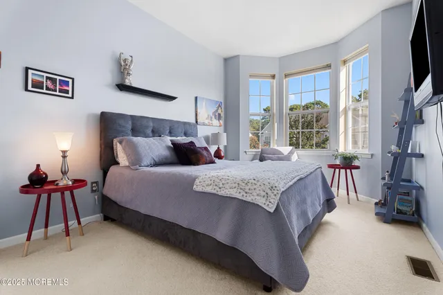 a bedroom with a bed and cabinets