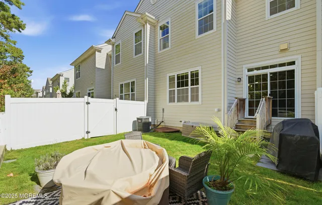 a view of backyard with seating area and trees