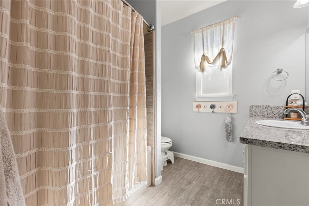 3465 Shaker Lane Chico, CA 95973 - Photo 15 of 34 a bathroom with a granite countertop sink toilet and shower