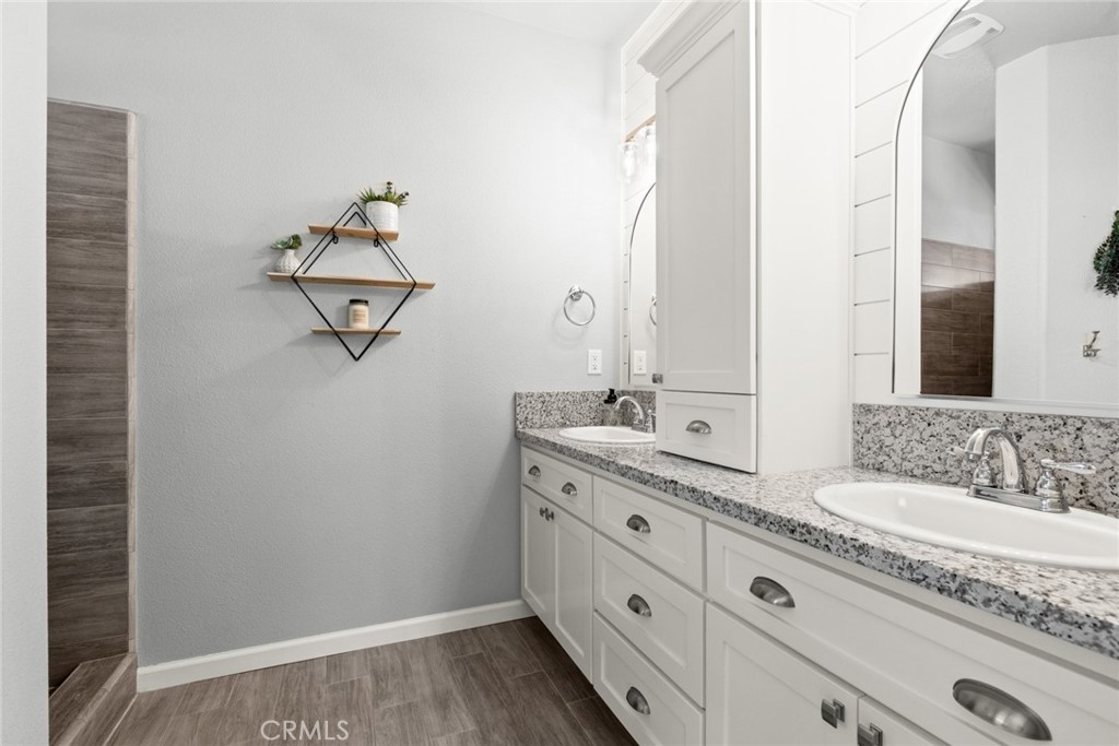 3465 Shaker Lane Chico, CA 95973 - Photo 19 of 34 a bathroom with a granite countertop sink double and mirror