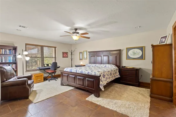 a bedroom with a large bed and dresser