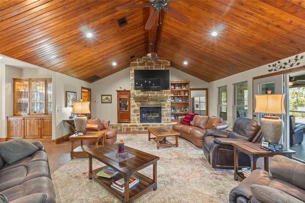 a living room with patio furniture and a fireplace