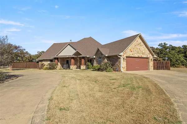 a front view of house with yard and green space