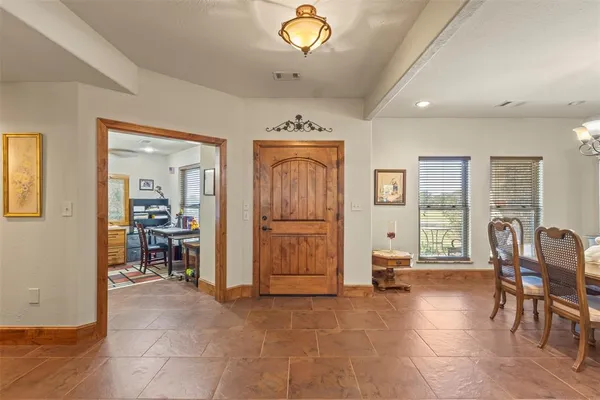 a view of a livingroom with furniture cabinet and windows