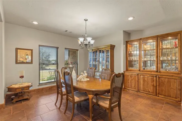 a dining room with furniture and window