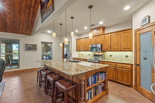 a kitchen that has a table and chairs in it