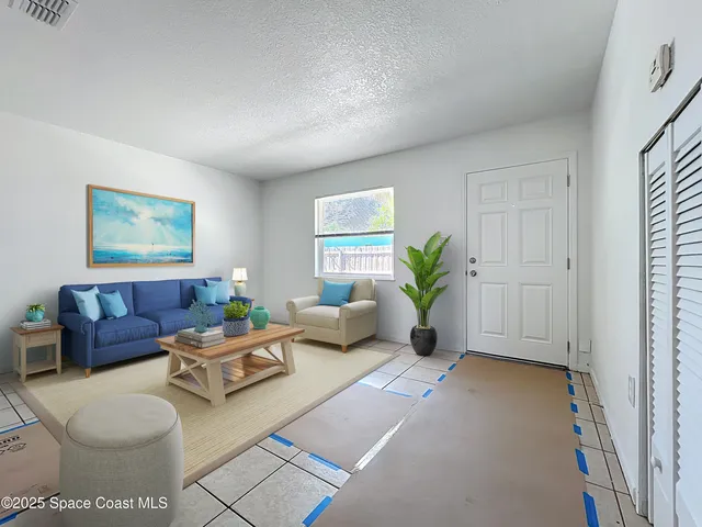 a living room with furniture flowerpot and a potted plant
