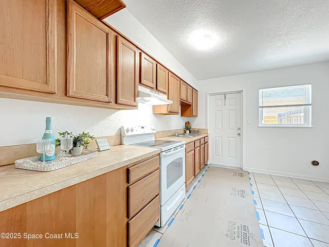 a kitchen with sink cabinets and window