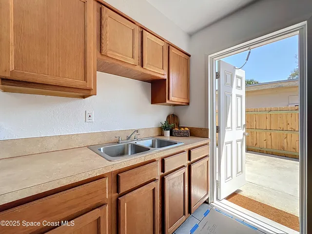 a kitchen with stainless steel appliances granite countertop a sink and cabinets