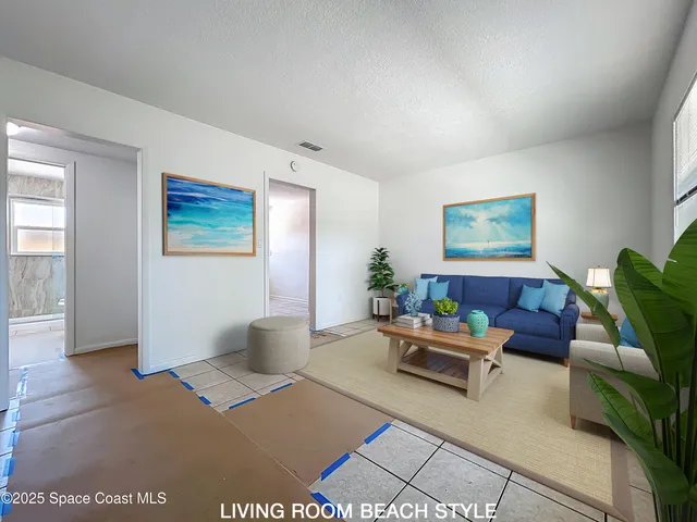 a living room with furniture and a potted plant