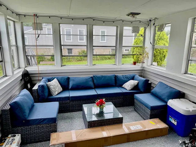 a kitchen with stainless steel appliances granite countertop a refrigerator a stove a sink a dining table and chairs