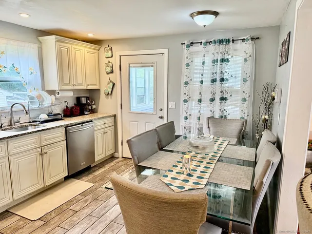 a kitchen with granite countertop white cabinets and a stainless steel appliances