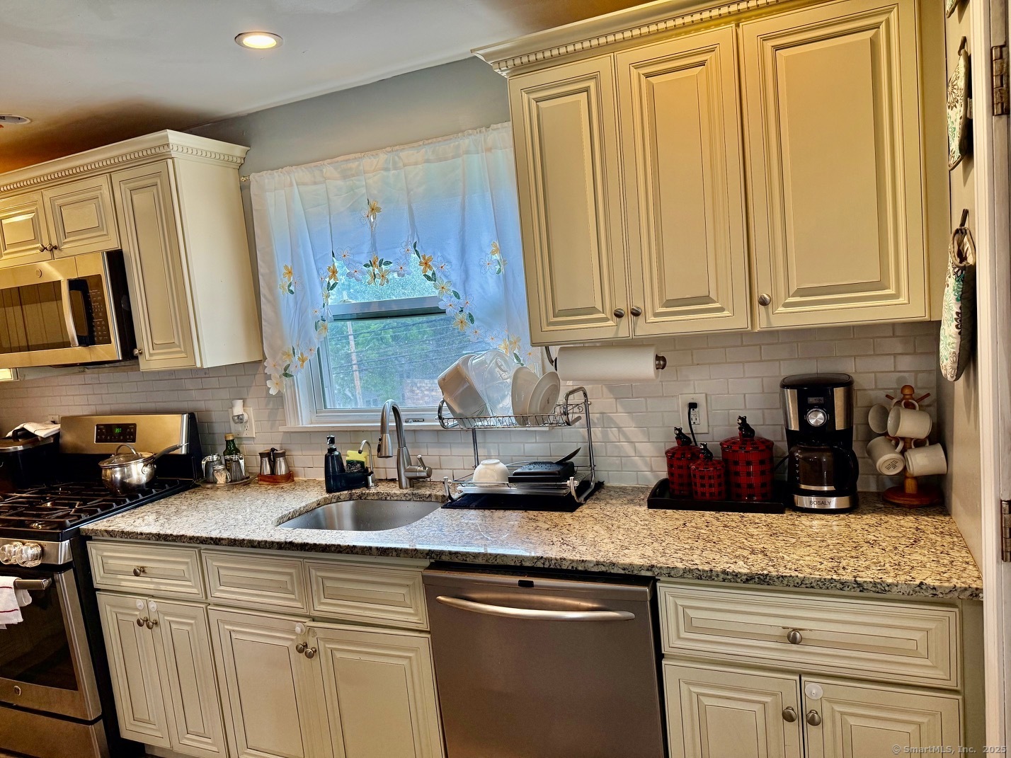 15 Edwards Street Bridgeport, CT 06606 - Photo 18 of 33 a kitchen with granite countertop white cabinets and a stainless steel appliances