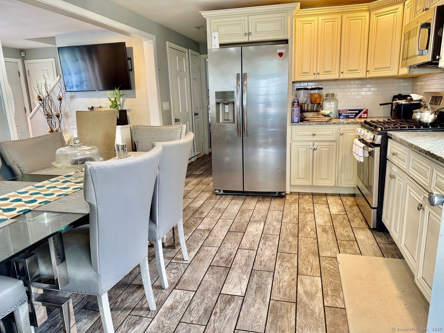 15 Edwards Street Bridgeport, CT 06606 - Photo 19 of 33 a kitchen with stainless steel appliances granite countertop a refrigerator a stove top oven a sink dishwasher and white cabinets
