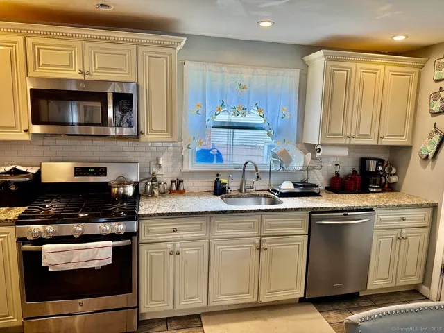 a bed room with a bed a couch and a window