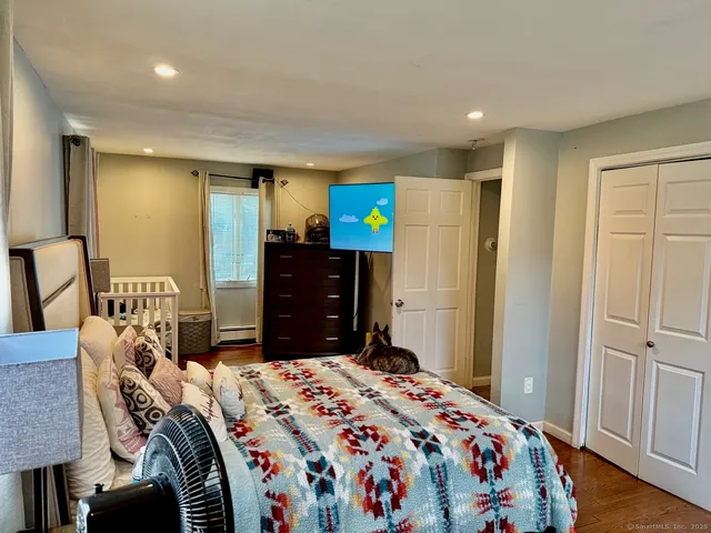 a bedroom with a bed and a mirror