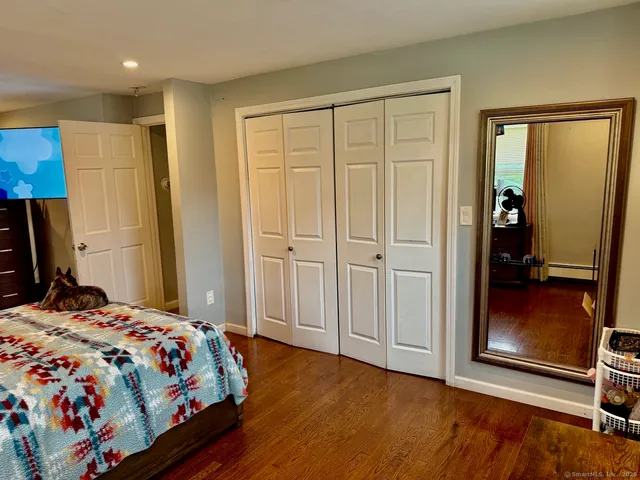 a bed room with furniture and a flat screen tv