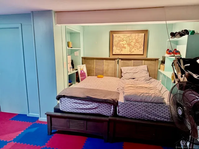 a bedroom with a bed and a flat screen tv