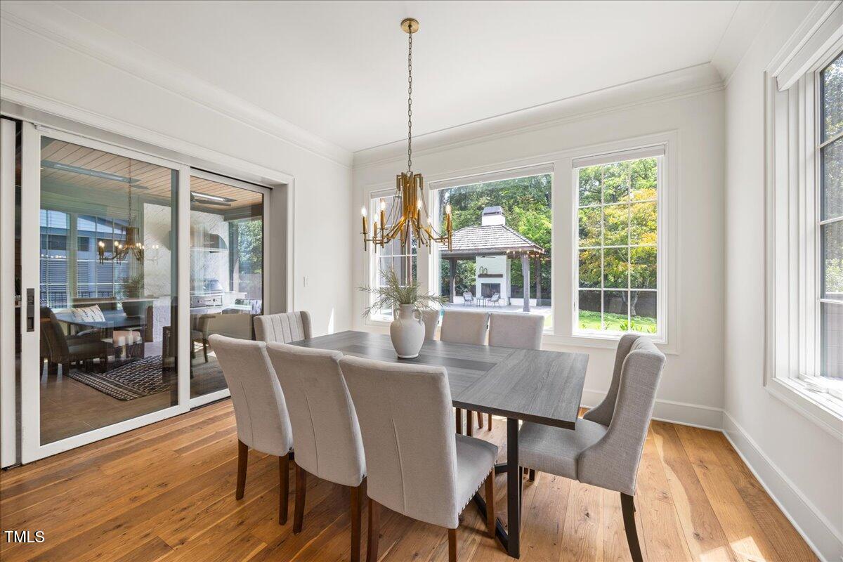2120 Kipawa Street Raleigh, NC 27607 - Photo 19 of 77 a view of a dining room with furniture window and wooden floor