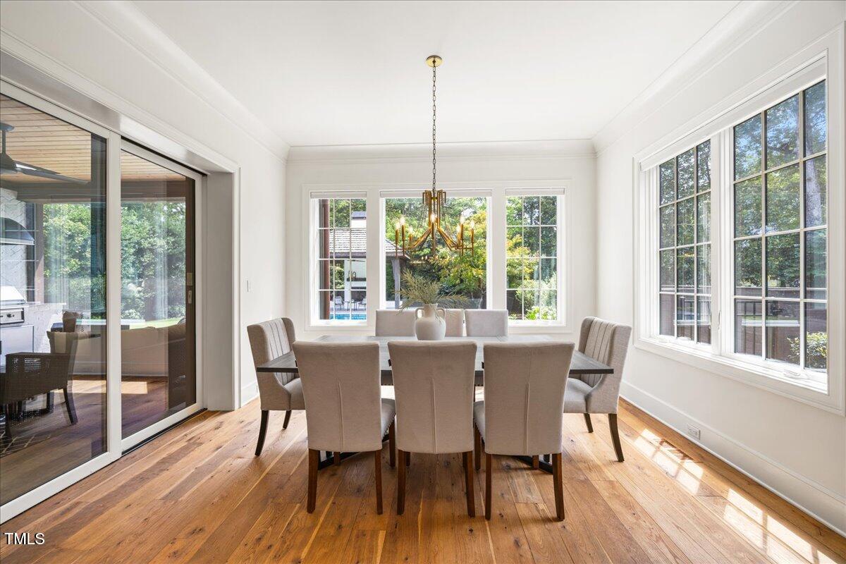2120 Kipawa Street Raleigh, NC 27607 - Photo 20 of 77 a view of a dining room with furniture window and wooden floor